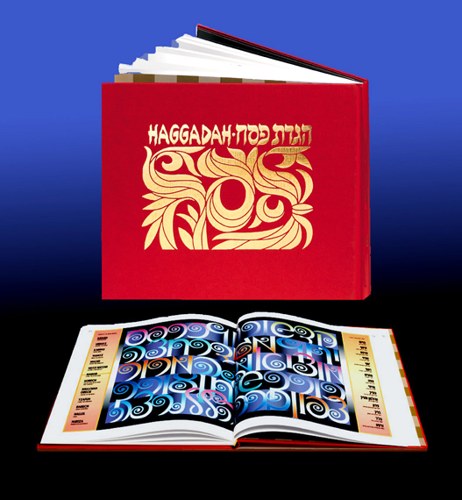 The New Passover Haggadah: a red hardcover book titled "Haggadah" in gold Hebrew and Latin lettering with flowing foliate ornament, shown above a copy lying open at a vivid blue and turquoise illuminated spread.
