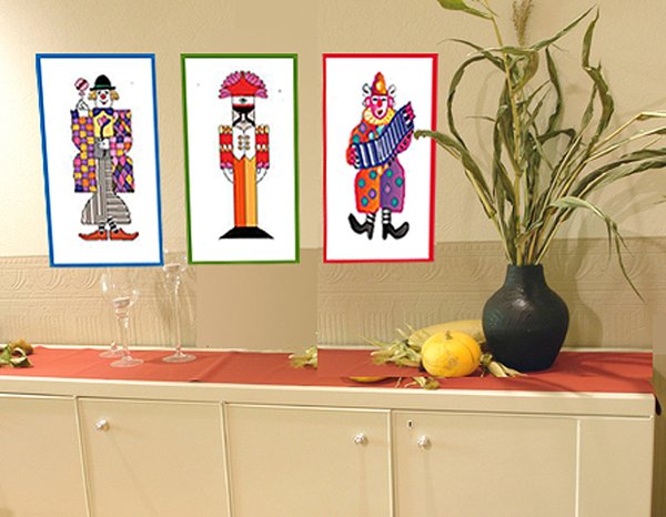Series 'Clowns': three framed illustrations of colourful harlequin-style clown figures in patterned costumes, displayed above a sideboard.